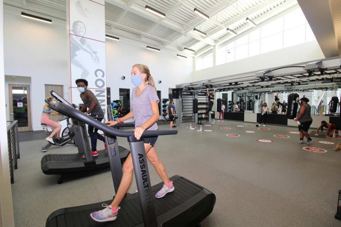 Patrons socially distanced walking on treadmills