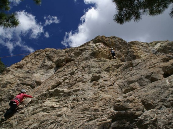 Climber scaling a mountain wall