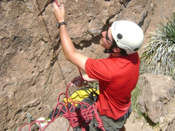 Climber adjusting climbing line