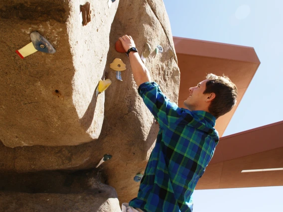 Campus Rec patron using the bouldering wall