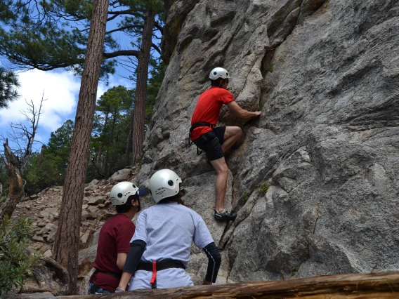 Group of climbers starting ascent along cliff