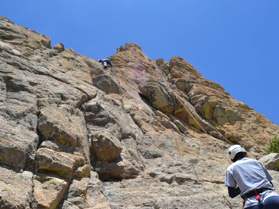 Group of climbers scaling up a rock cliff