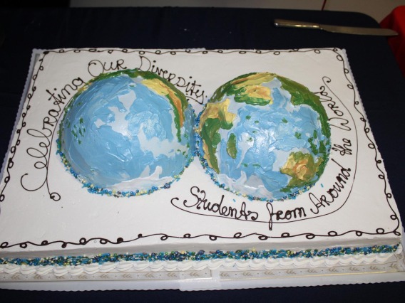 Cake with both halves of the globe, frosting reads: Celebrating our Diversity, students from around the world