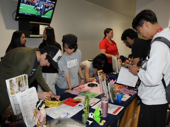 Group of students at informational booth at Campus Rec during diversity event