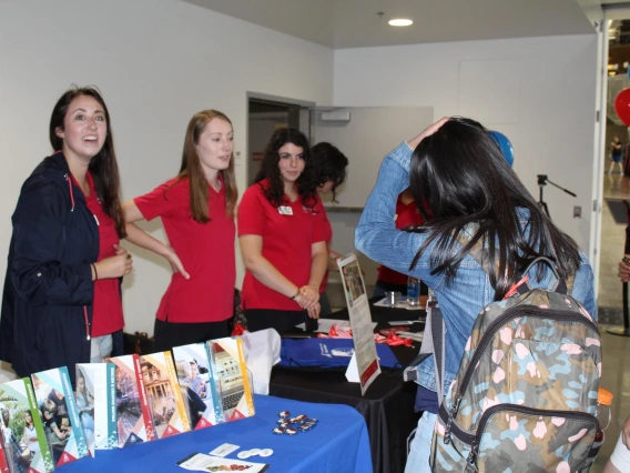 Students visiting informational booth at Campus Rec during diversity event