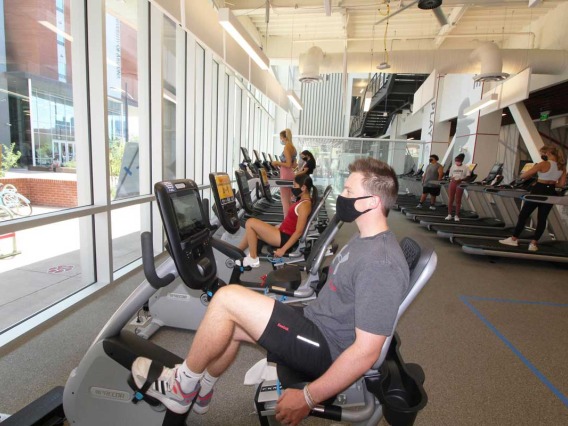 Patrons socially distances on treadmills and bikes
