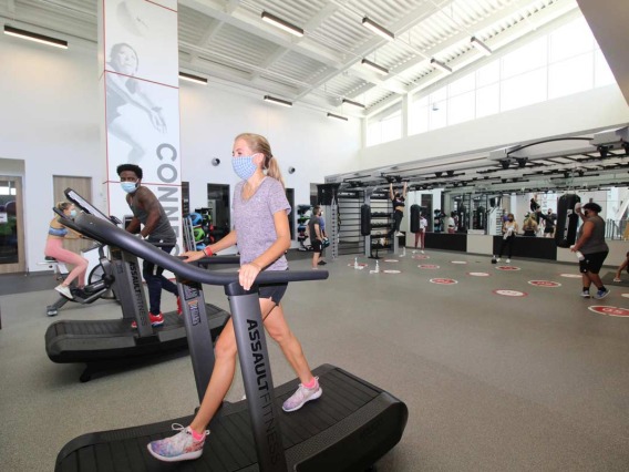 Patrons socially distanced walking on treadmills