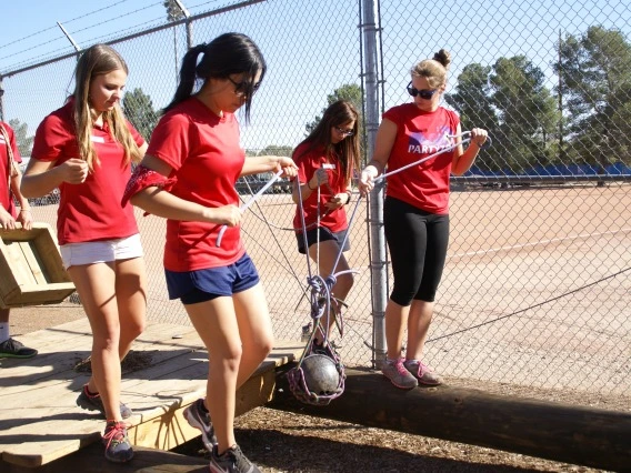 Group working together to carry item while balancing