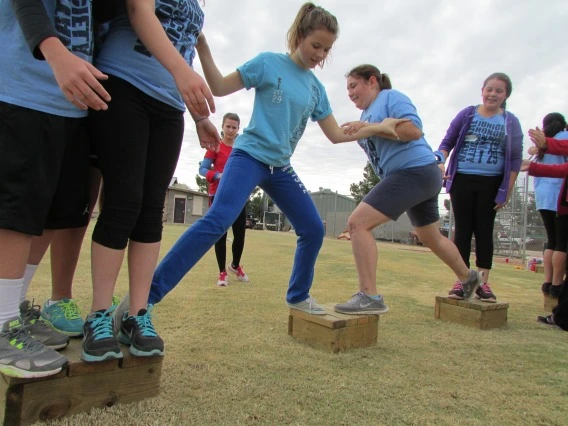 Group working together to cross spaced out platforms