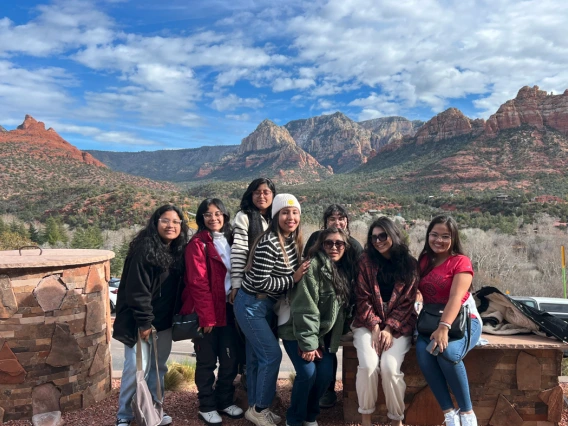 Group standing in front of mountains background