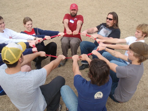 Group working together to carry item while balancing