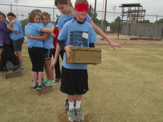 Group working together to carry items while balancing