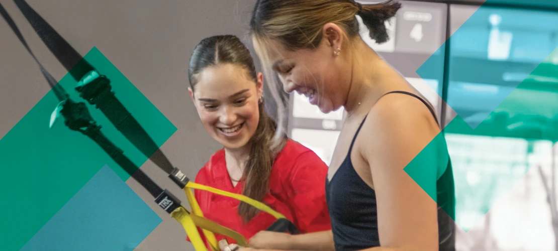 Female fitness staff working with a participant.