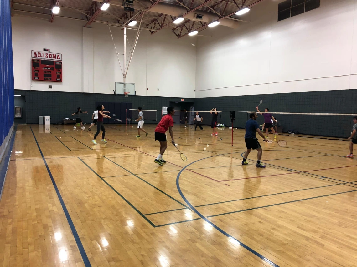 Badminton players playing on badminton court at UArizona