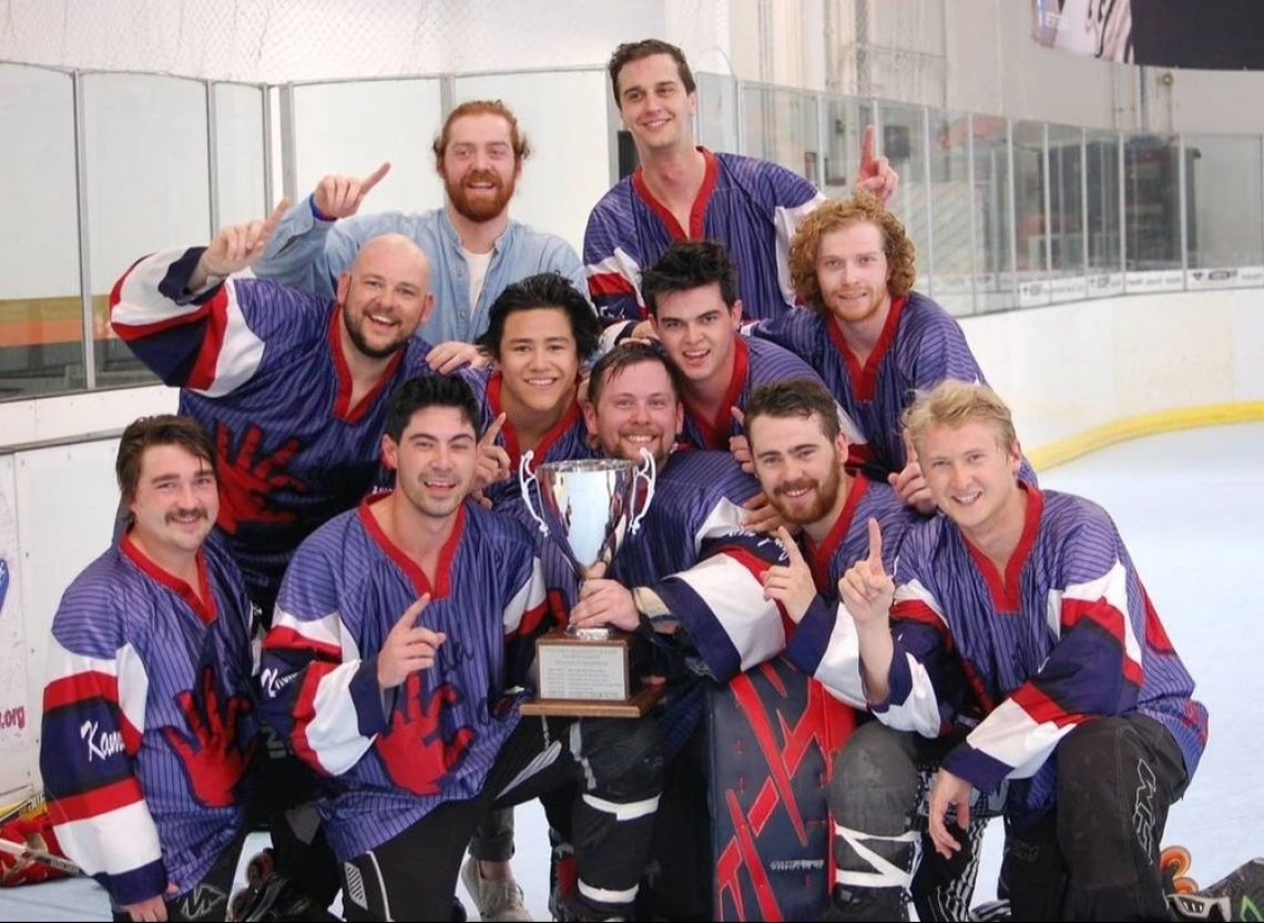 Roller hockey team posing for photo with trophy