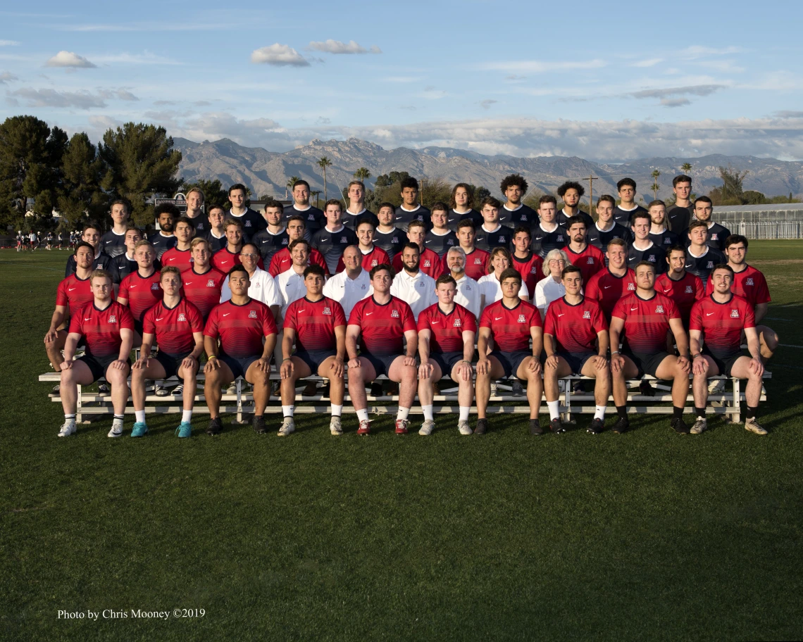 Men's Rugby team sitting on bleachers for team photo