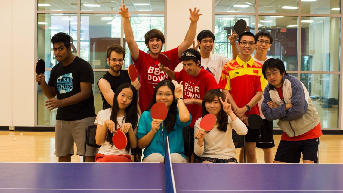 Table Tennis team posing for team photo and making silly faces and poses