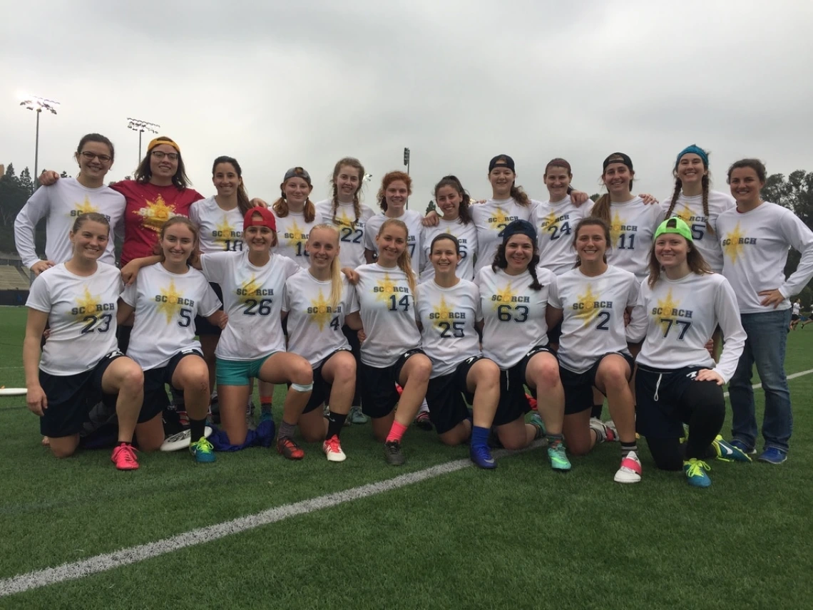 Women's Ultimate team posing for team photo on field