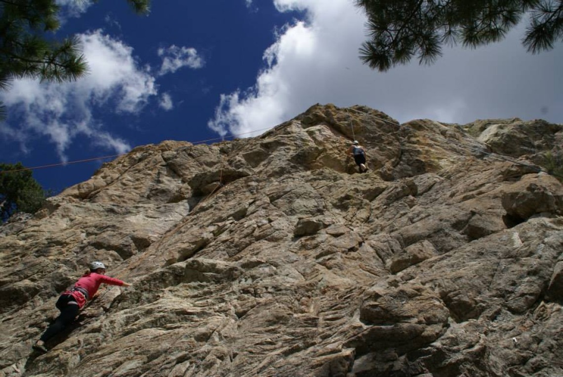 Climber scaling a mountain wall