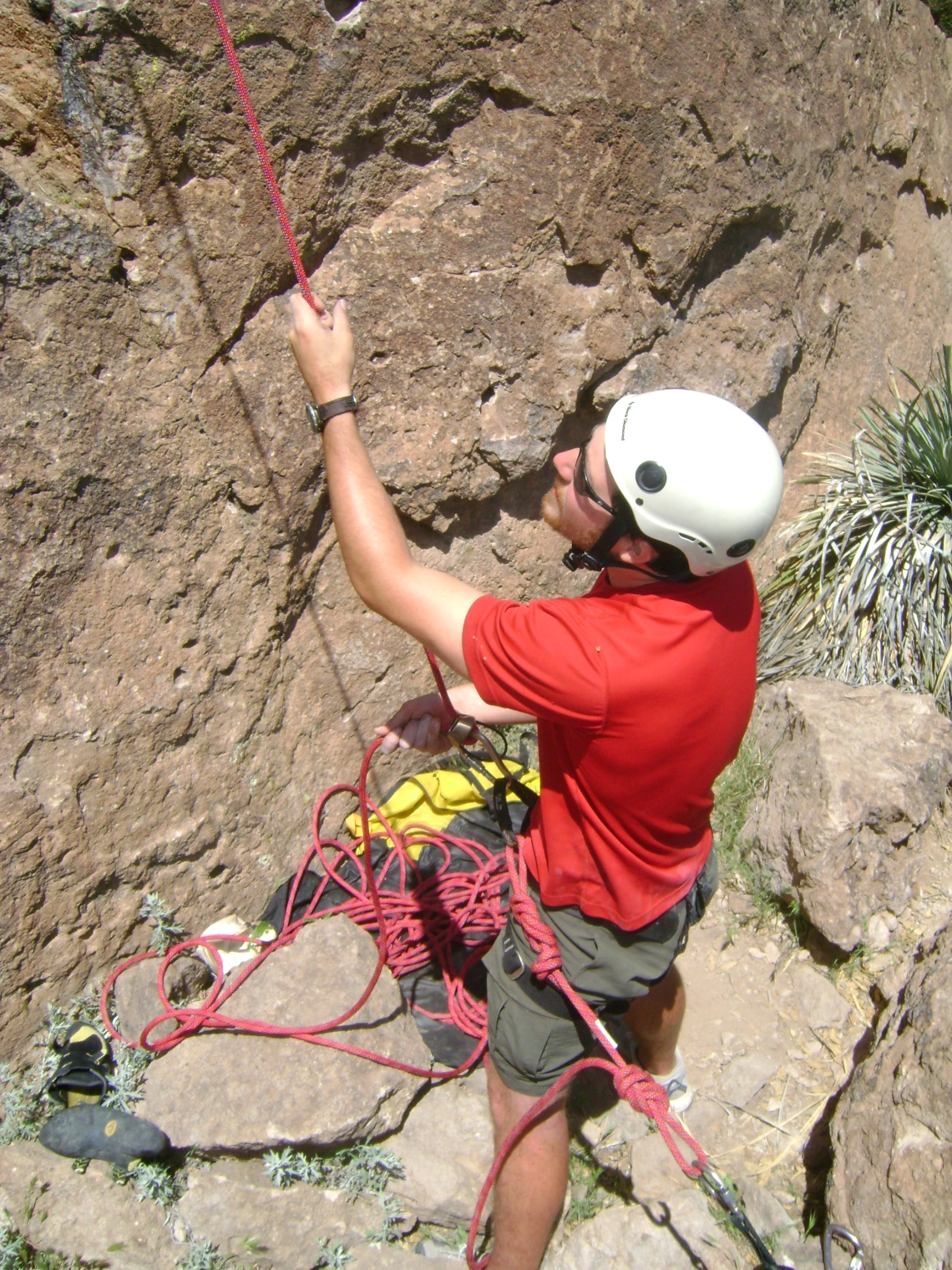 Climber adjusting climbing line