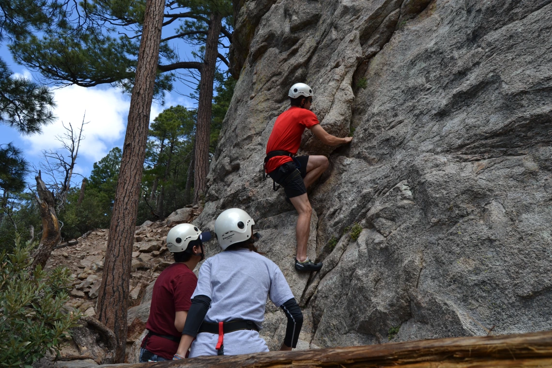 Group of climbers starting ascent along cliff