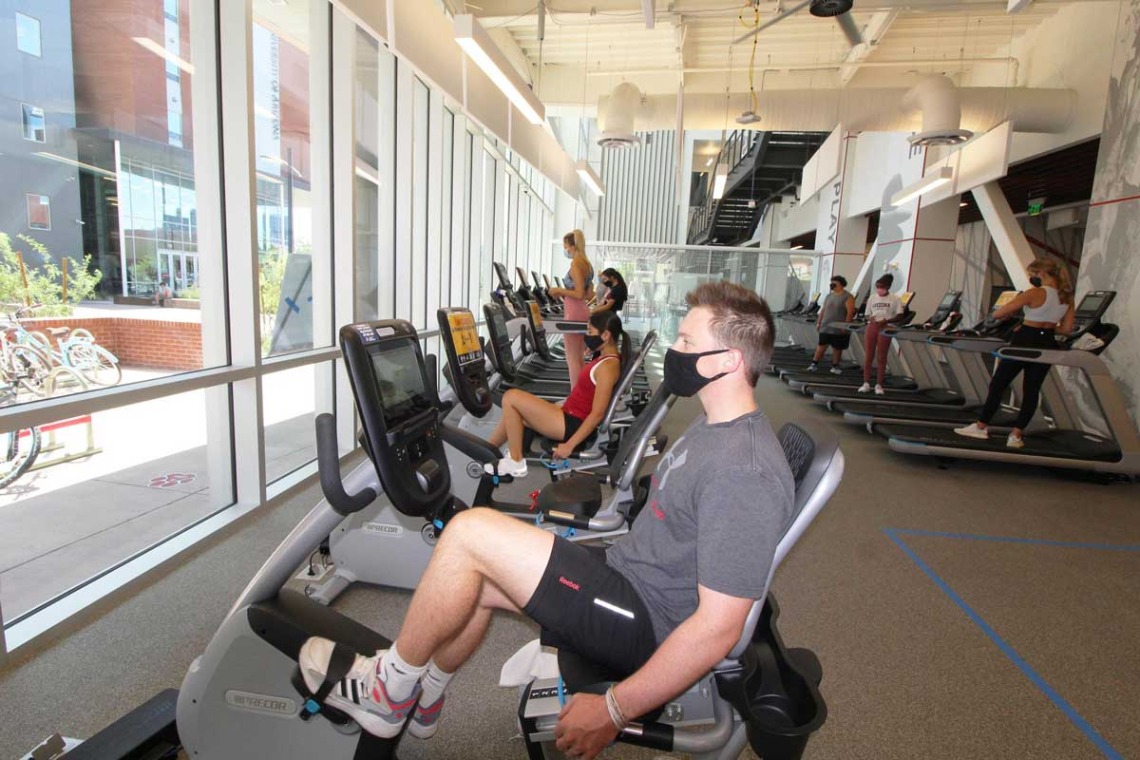 Patrons socially distances on treadmills and bikes