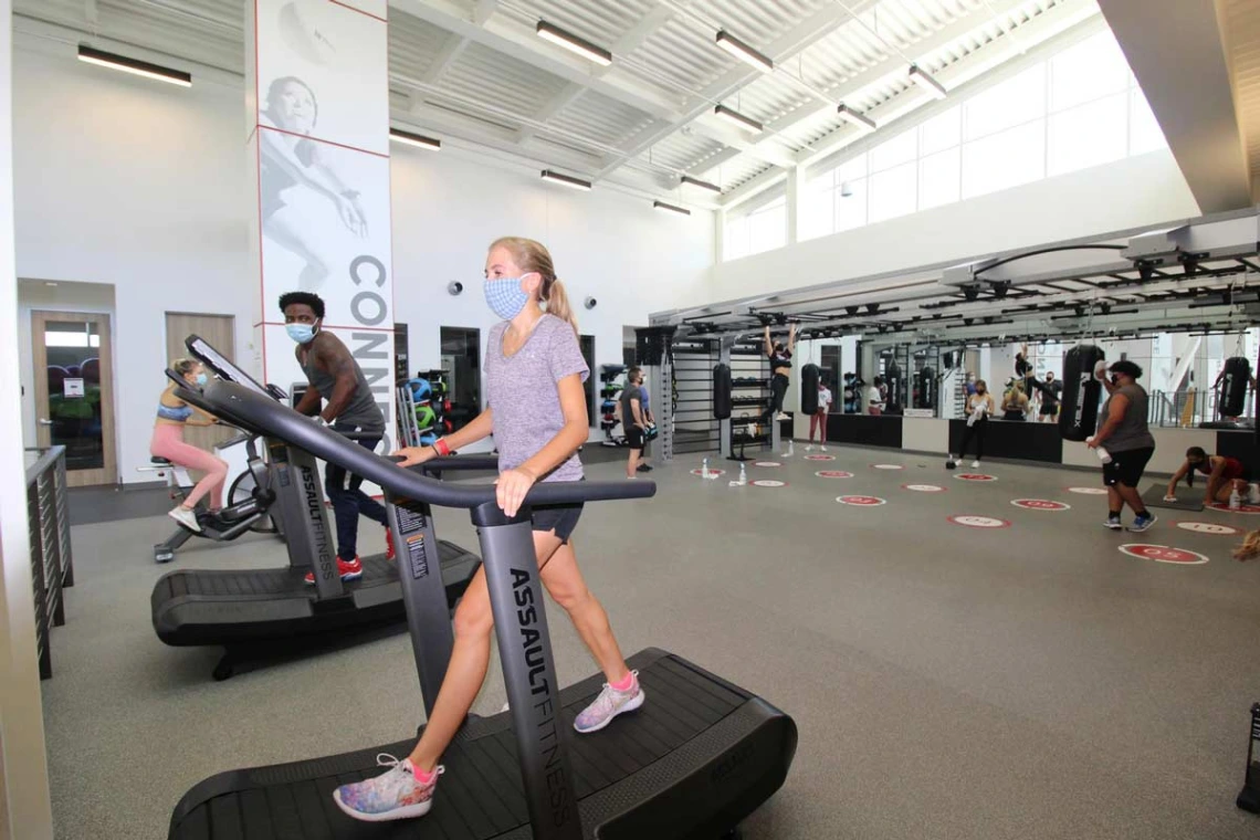 Patrons socially distanced walking on treadmills