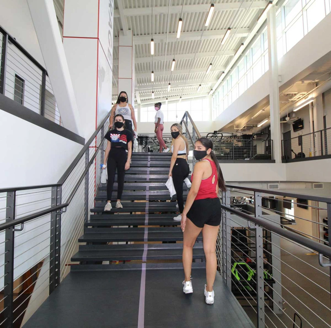 Group of patrons walking up staircase