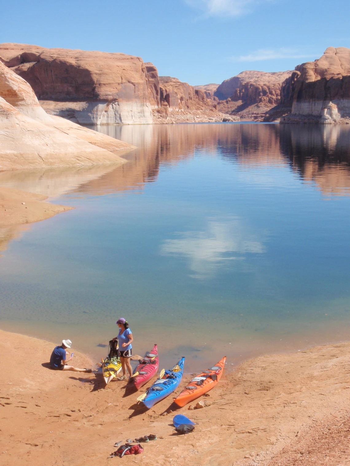 Group of kayakers on the shore of a lake