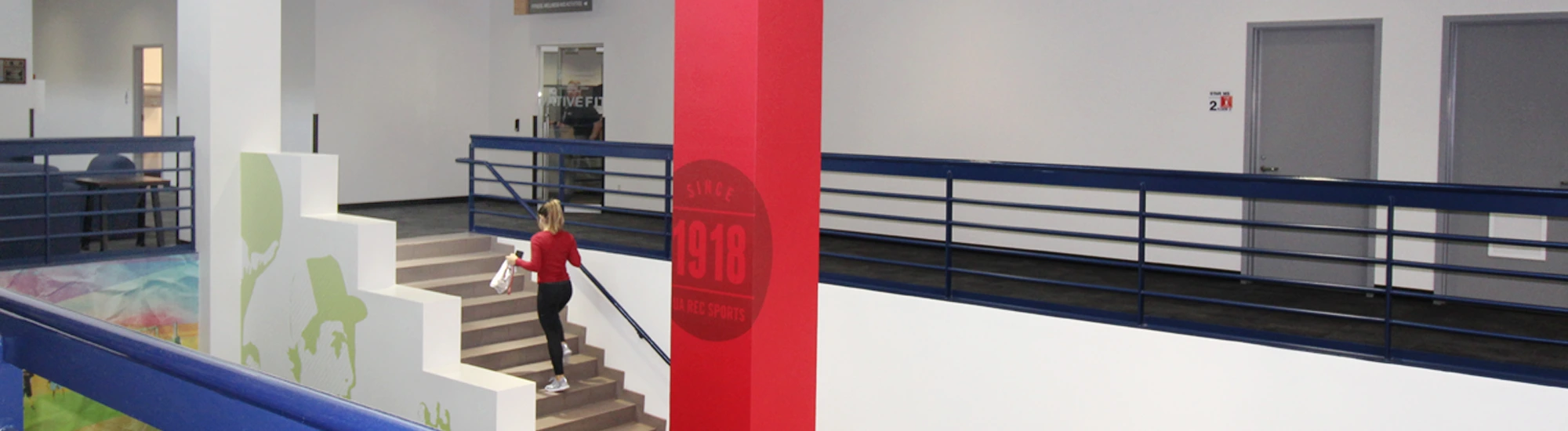 Campus Rec employee climbing the stairs towards the business office