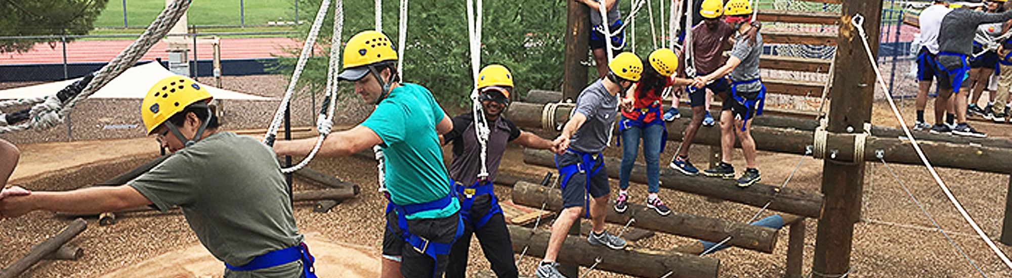 Group of people working together to complete an obstacle course