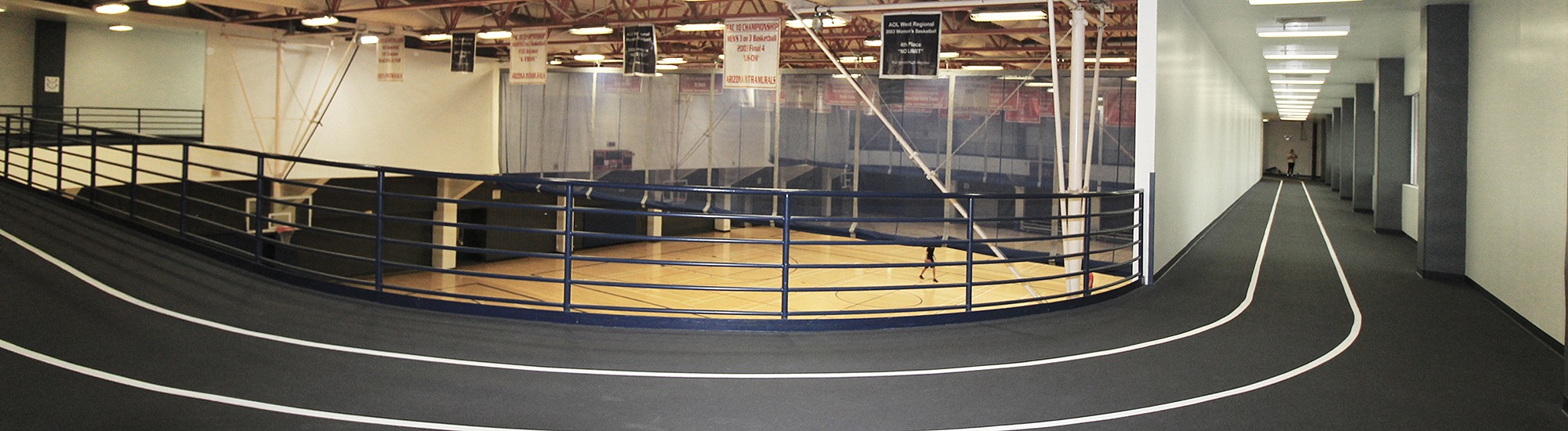 Indoor track on the second floor of a gym, basketball courts visible in the center of the track