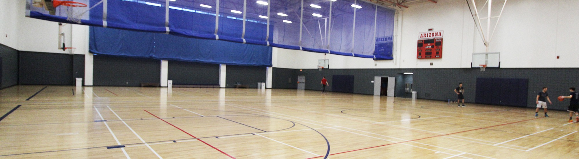 Group of people playing basketball at North Gym, UArizona