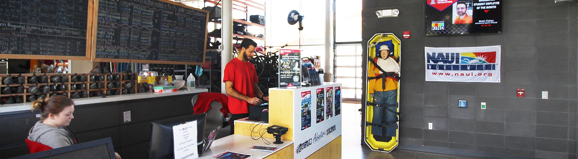 Two student employees attending the rental center counter at Outdoor Rec, UArizona