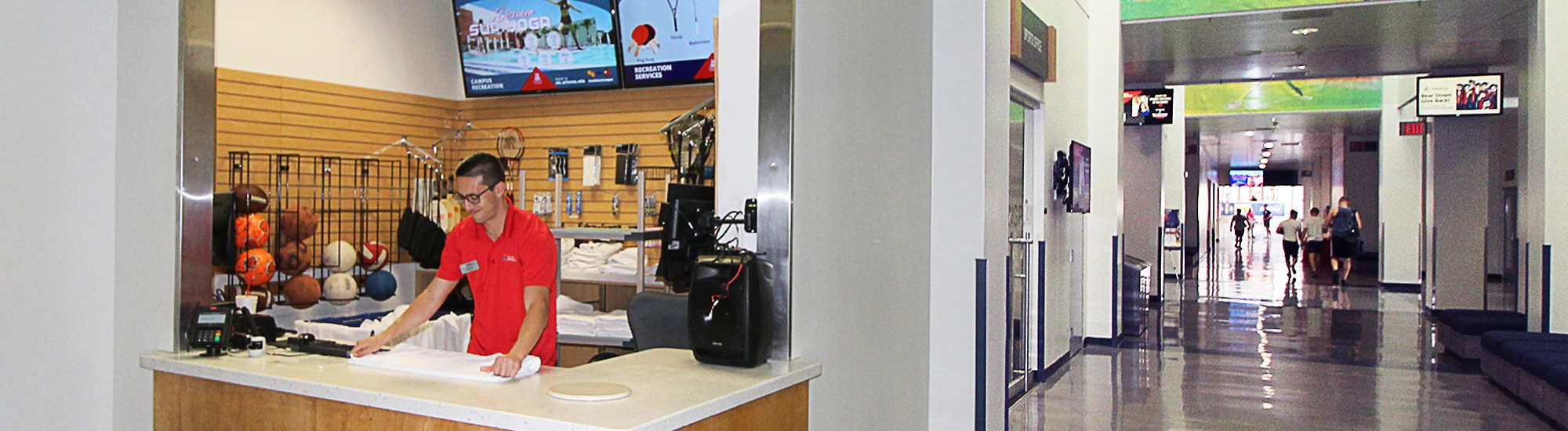 Campus Rec employee stationed at equipment checkout counter