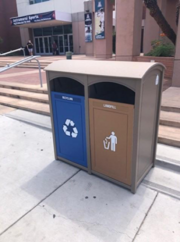 Trash and recycle bins outside Campus Rec main entrance