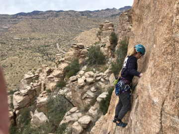 Devon Chapman rock climbing on the side of a mountain