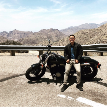 Ryan Ring sitting on motorcycle on side of highway