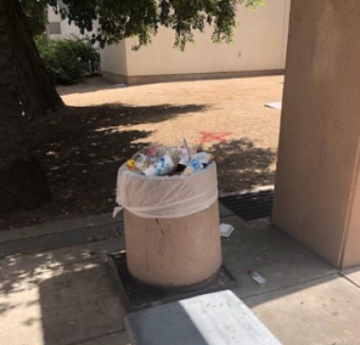 Overflowing trash can, trash on ground