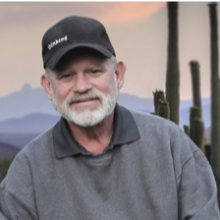 Headshot of Ric Nielsen with saguaro cacti in background