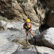 smiling human rappelling canyoning 