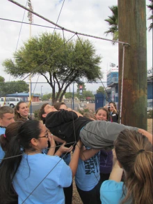 Group working together to lift partner